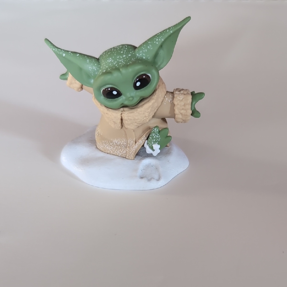 Green Baby Yoda Figurine with Beige Coat In Snow
